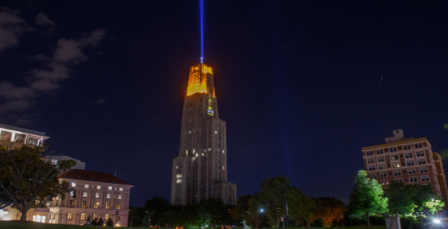 Cathedral of Learning at night with victory lights on.