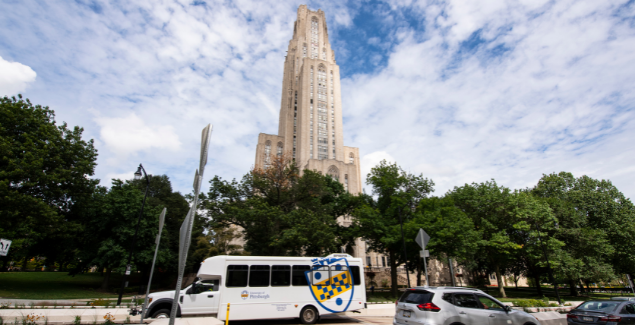 Pitt Shuttle parked in front of the Cathedral of Learning.