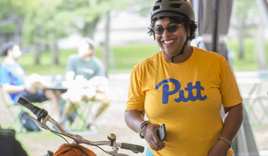 Smiling woman in a bike helmet.