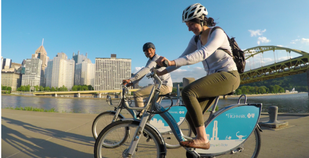 Healthy Ride users biking near the river. 