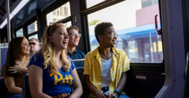 Pitt students riding a Pittsburgh Regional Transit bus. 